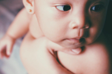 Baby looking at something outside of the frame.