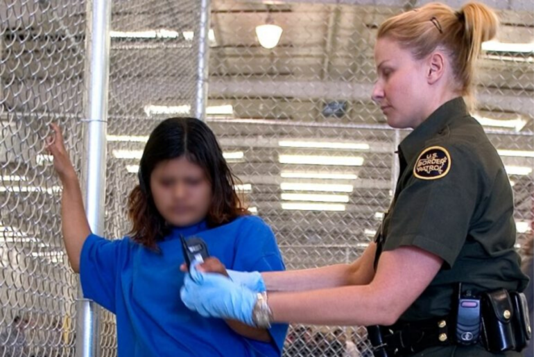 CBP agent conducts a pat down of a child.