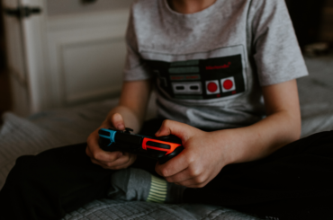 Adolescent playing video game.