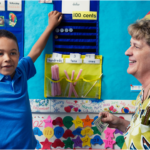 Boy at school learning about money.