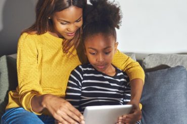 Mother and daughter using tablet together.