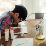 Boy engaged in a learning activity at home.