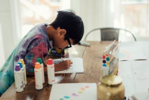 Boy engaged in a learning activity at home.