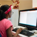 Student working at a computer at home.
