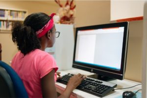 Student working at a computer at home.