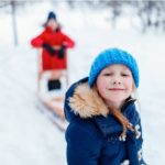 Kids playing happily in the snow.