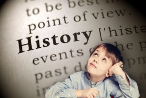 Boy thinking over background of "History" dictionary listing. How you can explain the importance of learning Black history to kids.