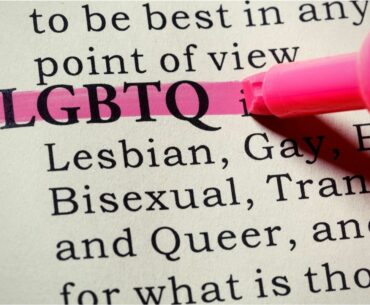 Close up of pink highlighter marking the word LGBTQ in dictionary.