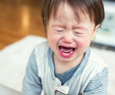 Upset toddler crying to demonstrate need for coping strategies