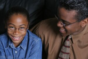 Proud girl smiling with her father.