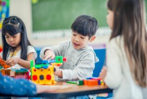 Children at a table in a classroom.