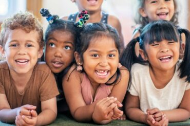 Diverse group of smiling school children.