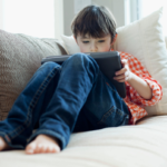 Young boy playing on iPad