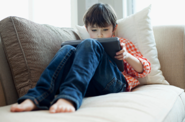 Young boy playing on iPad
