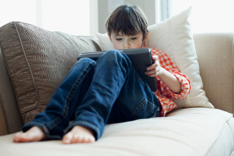 Young boy playing on iPad