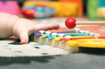 Baby's hand reaching for toy.
