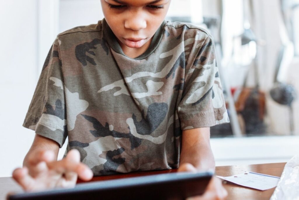 A child does some research using a tablet