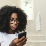 Teen at home looking at smartphone.