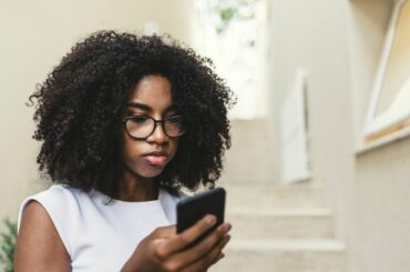 Teen at home looking at smartphone.