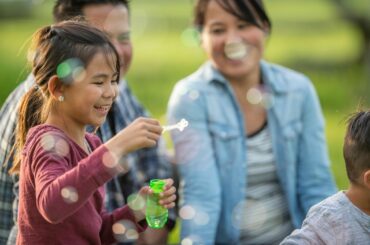 Family blowing bubbles.