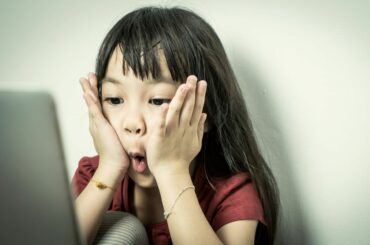 Surprised girl looking at a laptop screen.