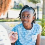 Woman and preteen talking on a bench.