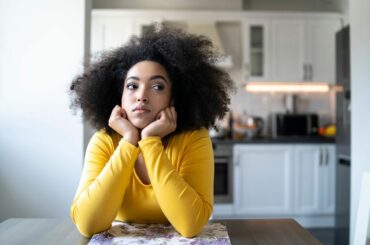 Woman sitting alone at home.