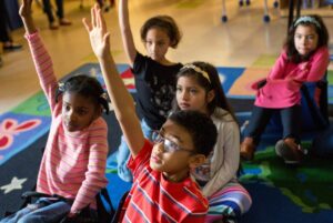 Students raising hands.