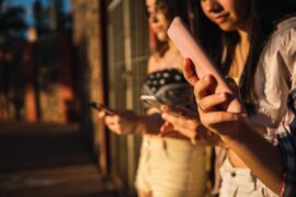 Focus on phones in teenagers' hands.