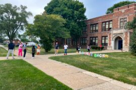Parents walk their children to school at Mark Twain School for Scholars in Detroit