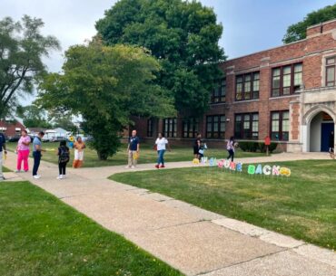 Parents walk their children to school at Mark Twain School for Scholars in Detroit