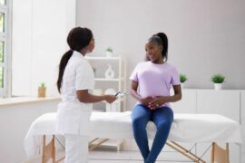 Pregnant Black woman with a nurse