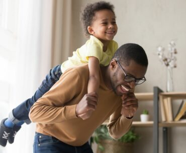 Dad giving boy a piggyback ride