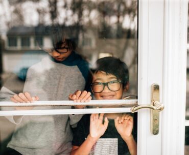 Sibling brothers looking out the front door