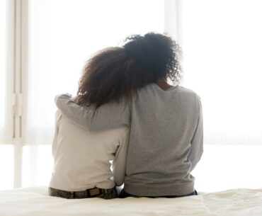 Supportive parent with arm around teen