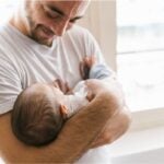 New dad holding newborn