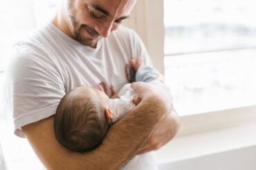 New dad holding newborn