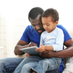 Dad and child watching a tablet