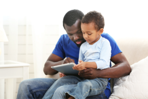 Dad and child watching a tablet