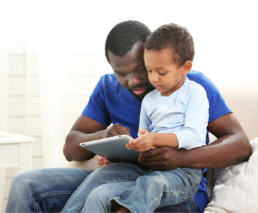 Dad and child watching a tablet