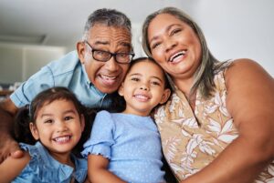 Grandparents smiling with grandkids