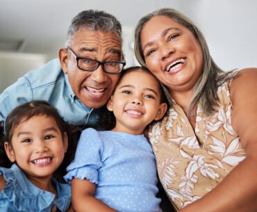Grandparents smiling with grandkids