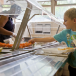 Child getting school lunch.