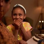 Kid laughing at family joke