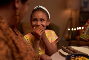 Kid laughing at family joke