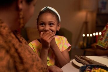 25 holiday jokes to tell your kids on Halloween, Valentine’s Day, and more Kid laughing at family joke