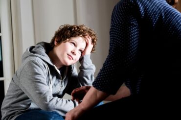 Preteen boy talking to parent