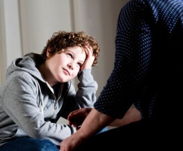 Preteen boy talking to parent