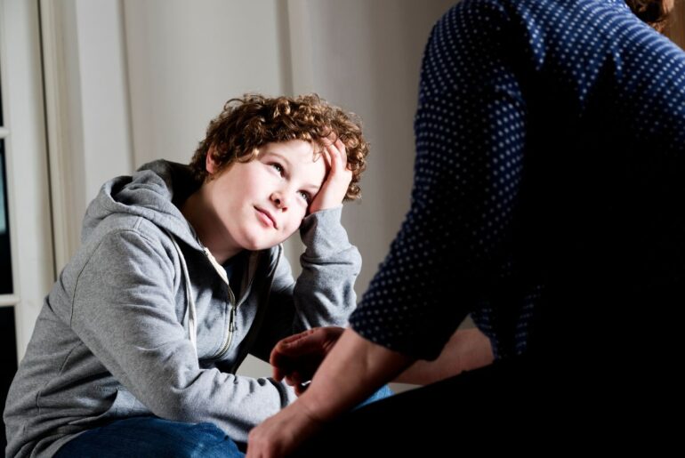 Preteen boy talking to parent