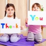Kids holding thank you signs
